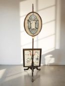 A Victorian mahogany pole screen and a further oak tapestry firescreen.