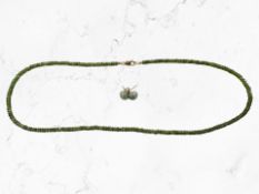 A pair of jade ear studs with 9ct gold backings,