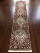 A Tabriz runner, 310 cm x 66 cm.