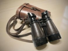 A pair of French Le Petit binoculars in leather case.