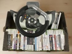 An Xbox 360 gaming steering wheel and a collection of video games.