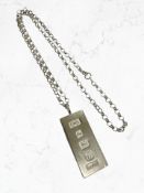 A silver ingot on silver belcher chain