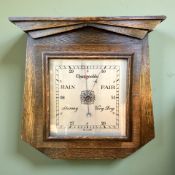 A 1930's English oak barometer with silvered dial, width 30 cm.