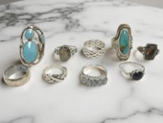 Nine silver/white metal dress rings, set with faux turquoise,