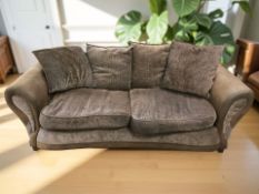 A contemporary brown leather and cloth three seater settee,