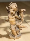 A German carved wooden figure of a cherub, circa 1900,