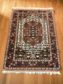 An Iranian rug, 186 cm x 128 cm.