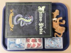 A quantity of Snoopy pin badges, a Scooby Doo nodding toy and a volume relating to tattoos.