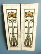 A pair of Art Nouveau tiled fireplace panels, each 97 cm x 29 cm.