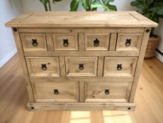 A modern pine nine drawer chest,