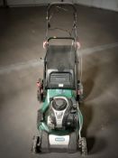 A Qualcast petrol lawnmower.