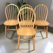 A reproduction set of four beech spindle back chairs.