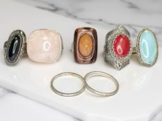 Seven silver/white metal dress rings, set with pink quartz, two full eternity rings,