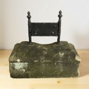 A weathered sandstone and wrought iron boot scraper, width 40 cm.