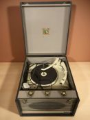 A vintage HMV portable record player.