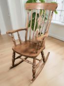 A reproduction beech rocking chair