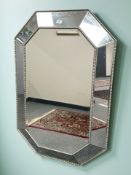 A contemporary cushion mirror, 121 cm x 53 cm.