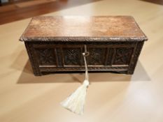A miniature carved oak coffer with key,