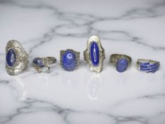 Six silver/white metal dress rings,