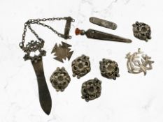 A group of silver and white metal items including ornate buttons,
