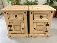 A pair of modern pine beside cabinets,