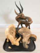 A carved wooden gazelle, rhino and elephant.