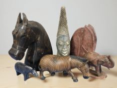 A group of wooden carvings and busts.