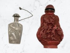 A Chinese cinnabar scent bottle, together with a further white metal oriental scent flask.