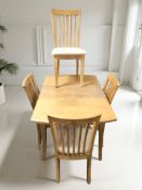 A contemporary pine effect extending dining table with internal leaves,