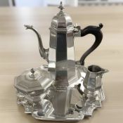 An Art Deco style pewter three piece tea service on tea tray with Procter & Gamble inscription,