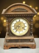 A late Victorian walnut eight day mantel clock with enameled dial, height 38 cm.