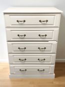 A contemporary white laminated wood five drawer chest, 83 cm x 52 cm x 122 cm.