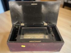 A 19th century cylinder music box in stained pine rectangular case, width 37 cm.