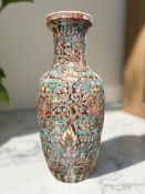 A Chinese porcelain baluster vase decorated with honeysuckle on rust ground, height 31 cm.