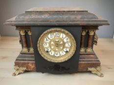 A 19th century faux marble mantle clock,