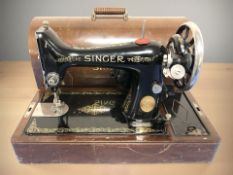 An antique hand Singer sewing machine in case