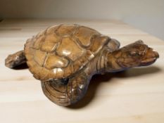 A wooden carving of a sea turtle,