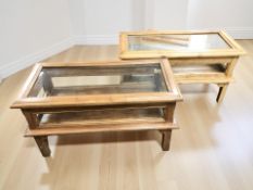 A pair of glazed hardwood display tables with hinged tops, each 80 cm x 40 cm x 44 cm.