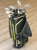 A Woodworm golf caddy containing irons and drivers including Cleveland, Calloway, etc.