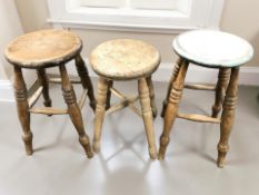 Three various turned pine stools, tallest 54 cm.