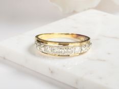 An 18ct yellow gold diamond half eternity ring, size N/O. CONDITION REPORT: 2.9g.