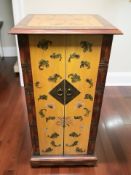 A contemporary double door CD pedestal cabinet in the form of an oriental chest, width 47 cm.