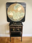 A reproduction oriental style side table fitted a drawer and pair of cupboard doors beneath,