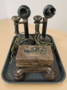 Two Bakelite candlestick telephones and a further Bakelite Gecophone on wooden stand.