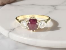 An 18ct yellow gold ruby and two stone diamond ring, size O. CONDITION REPORT: 2.8g.