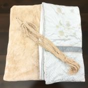 A faux fur throw / bed cover, a further bed cover and a woven rope plant pot hanger.