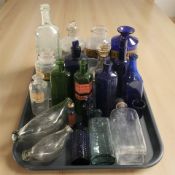 A collection of antique glass bottles, chemist's bottles.