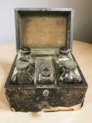 A 19th century chemist's box containing glass bottles.