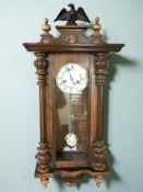 A walnut Vienna wall clock with enameled dial, height 86 cm.