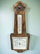 A carved oak barometer with square silvered dial, height 62 cm.